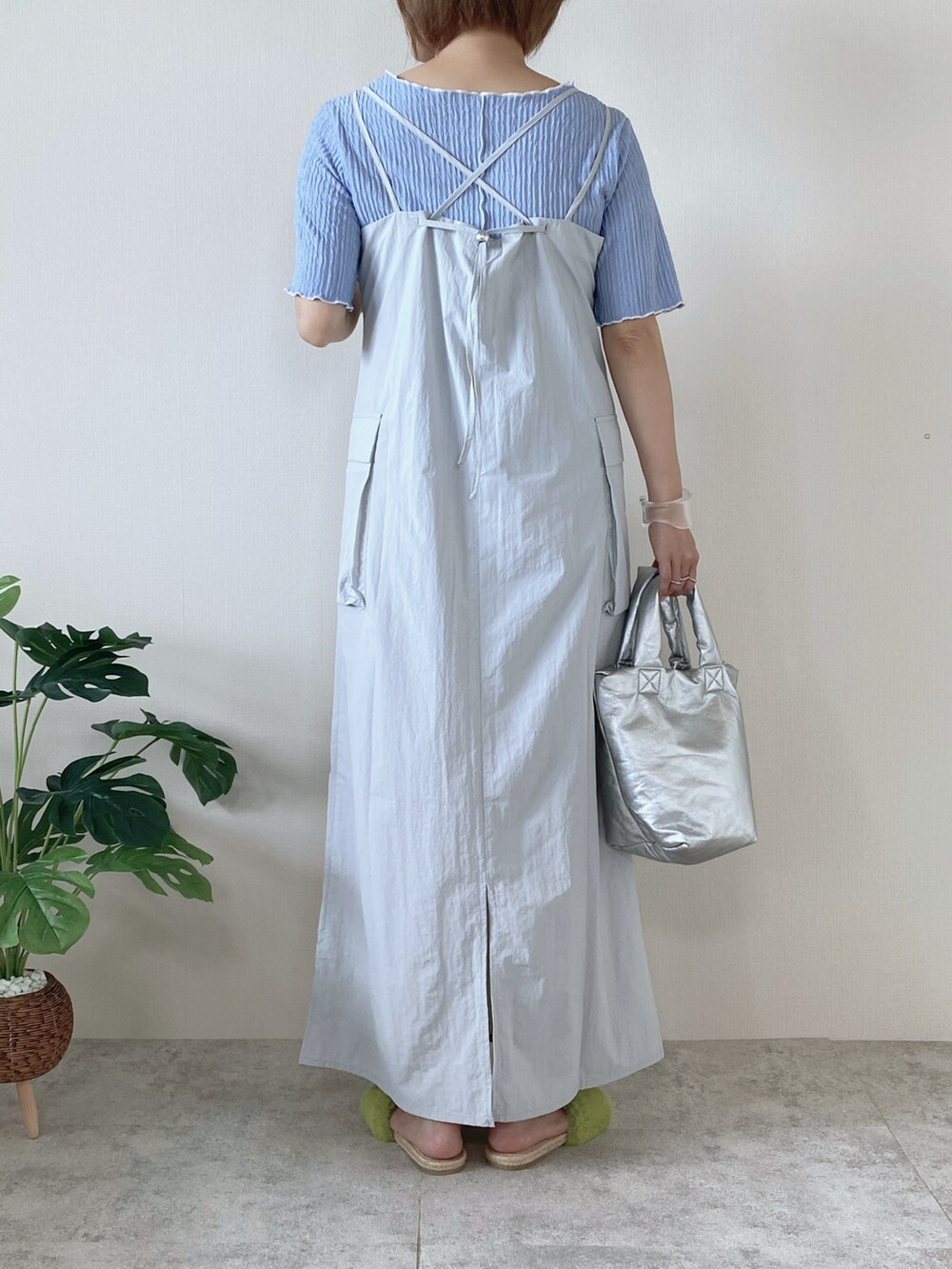 グレー系のワンピース、ブルー系のTシャツ/カットソー、シルバー系のハンドバッグを着用したレディースの夏コーディネートの2枚目の写真
