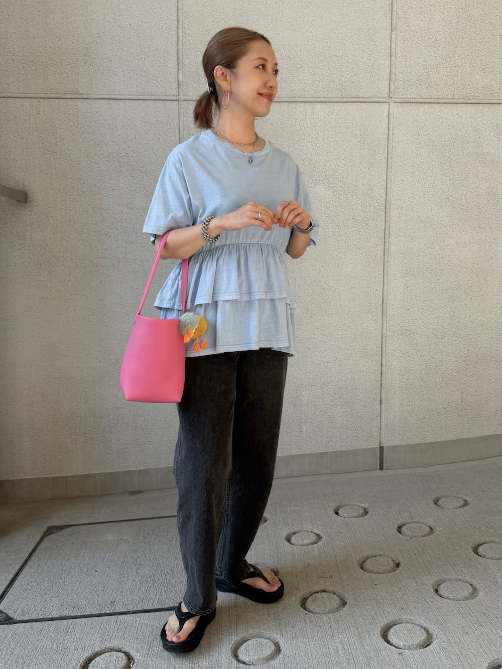 ブルー系のTシャツ/カットソー、ブラック系のデニムパンツ、ピンク系のショルダーバッグを着用したレディースの夏コーディネートの3枚目の写真