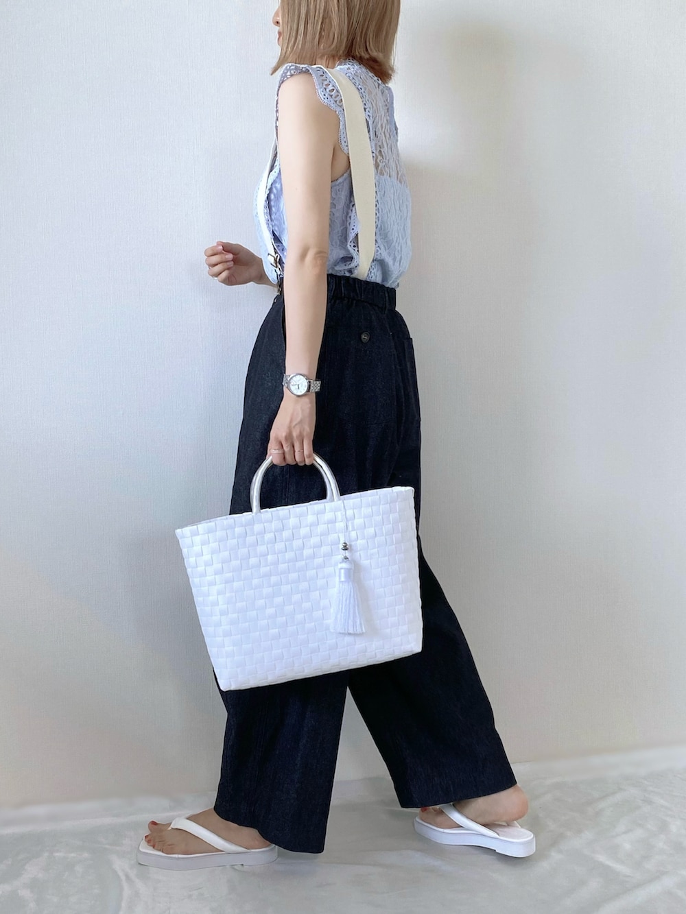 ブルー系のシャツ/ブラウス、ブラック系のデニムパンツ、ホワイト系のかごバッグを着用したレディースの夏コーディネートの2枚目の写真