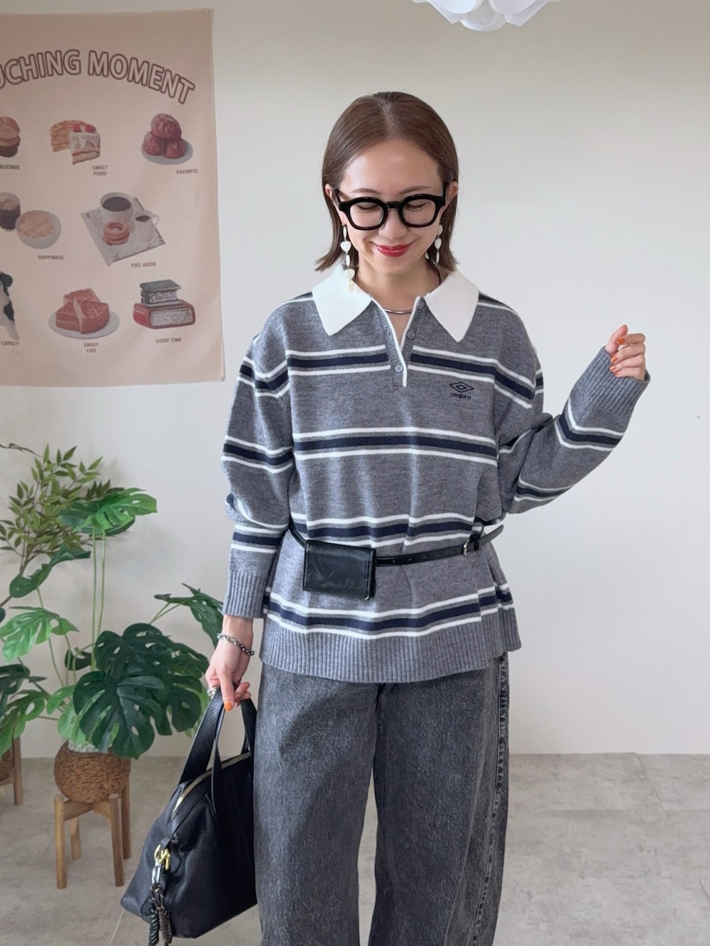 グレー系のニット/セーター、グレー系のデニムパンツ、ブラック系のベルトを着用したレディースの秋コーディネートの4枚目の写真