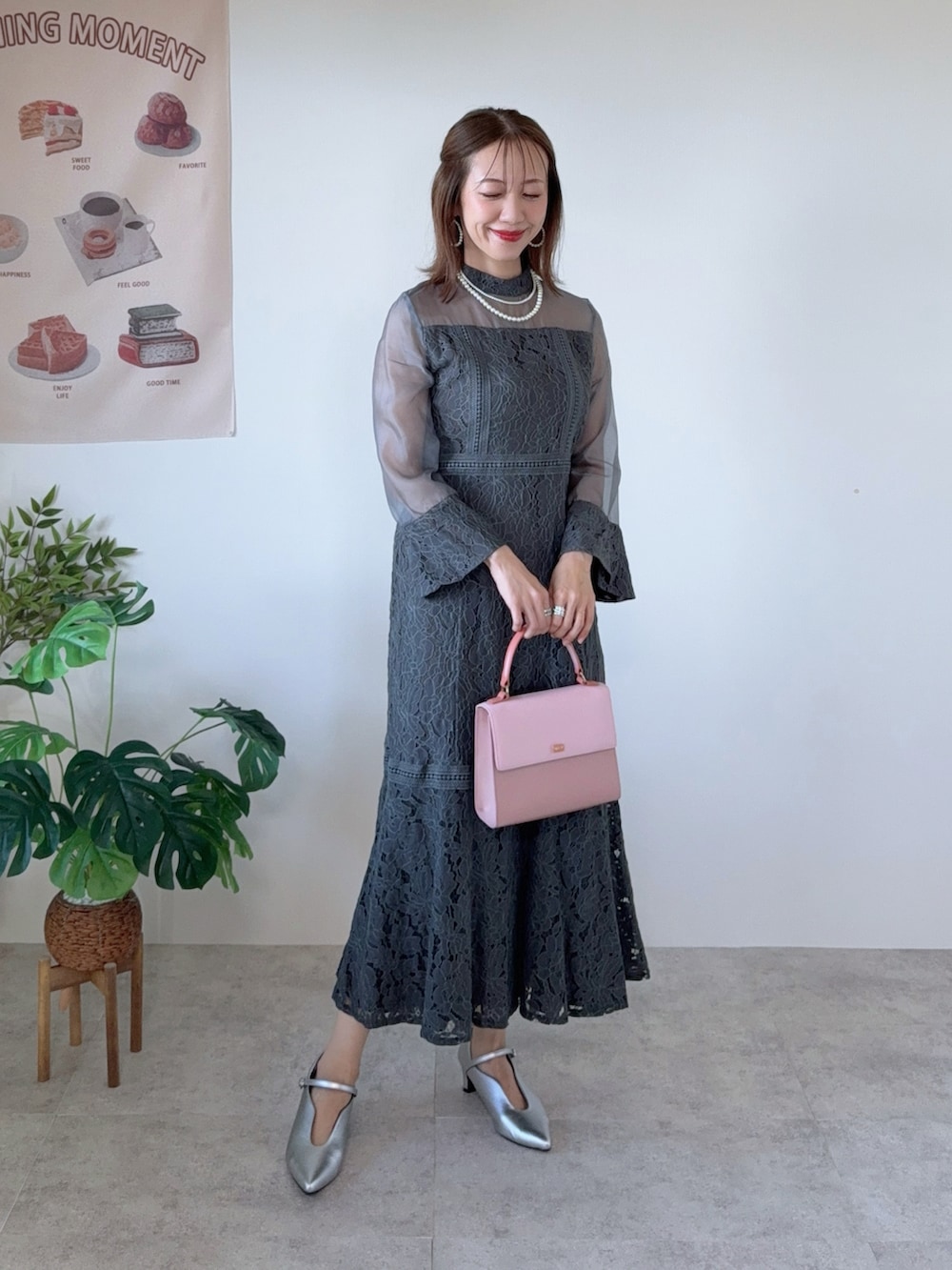 グレー系のドレス、シルバー系のパンプス、ホワイト系のネックレスを着用したレディースの夏コーディネートの2枚目の写真
