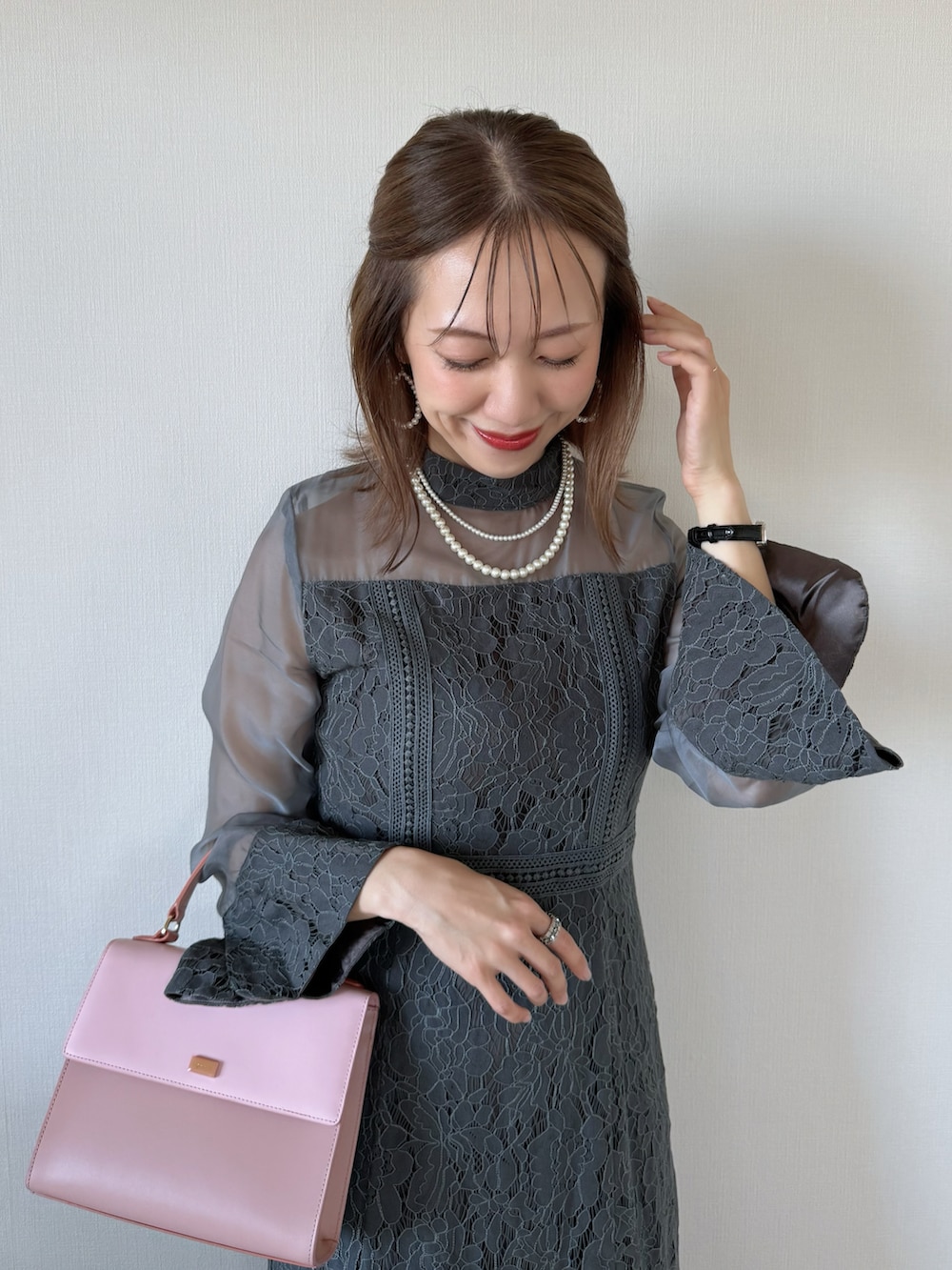 グレー系のドレス、シルバー系のパンプス、ホワイト系のネックレスを着用したレディースの夏コーディネートの5枚目の写真