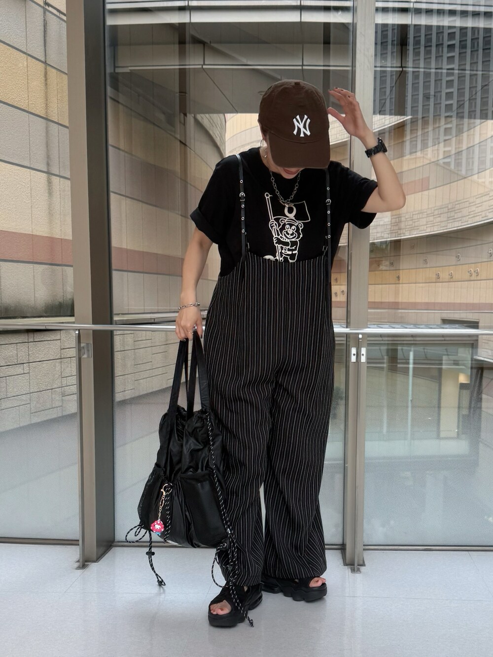 ブラック系のサンダル、ブラック系のTシャツ/カットソー、ブラック系のその他パンツを着用したレディースの秋コーディネートの2枚目の写真