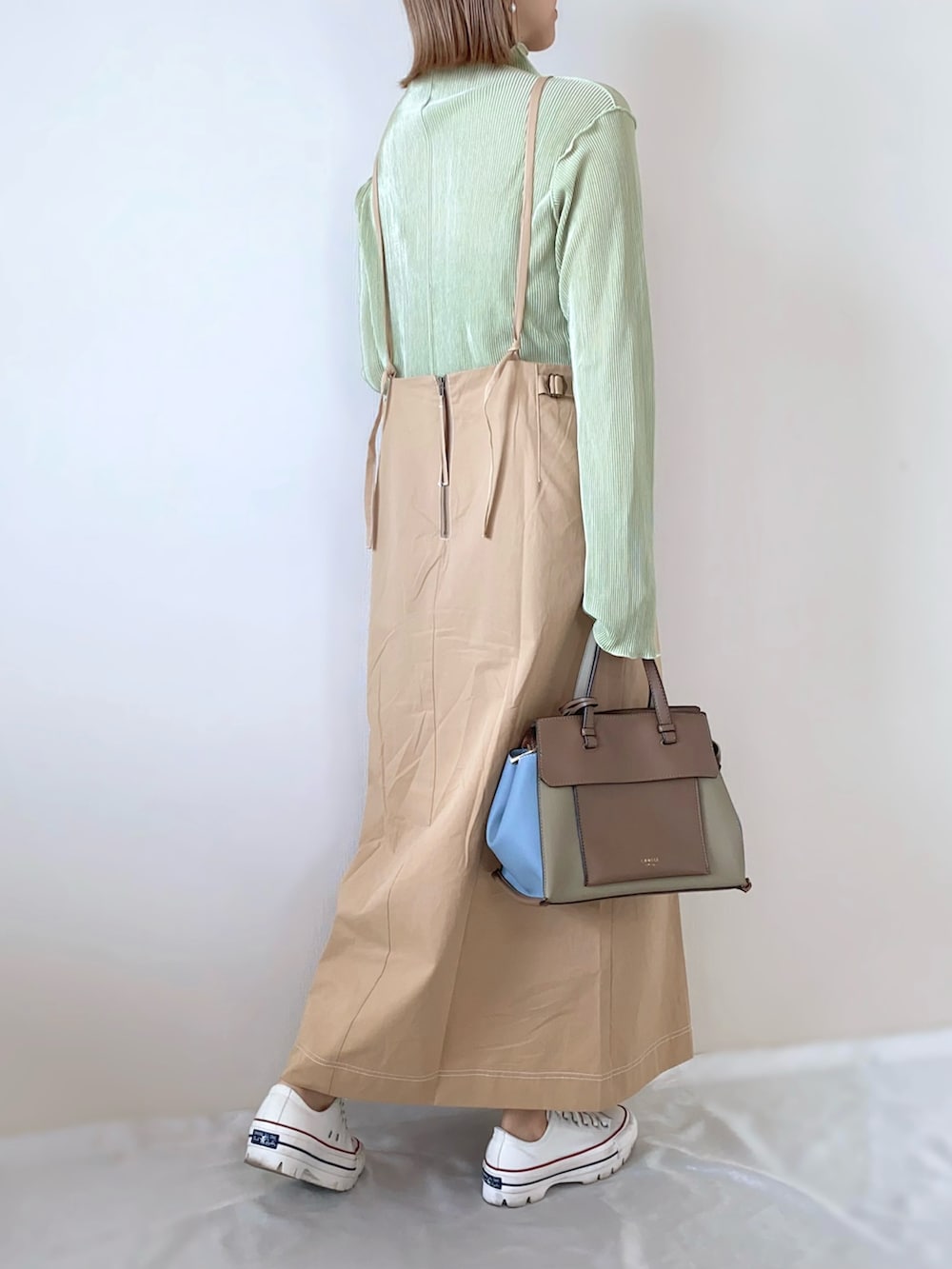 その他のトートバッグ、ホワイト系のスニーカー、グリーン系のTシャツ/カットソーを着用したレディースの春コーディネートの3枚目の写真