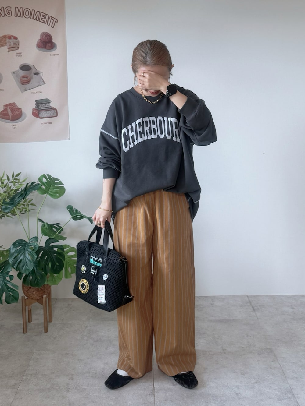 グレー系のスウェット、ブラウン系のその他パンツ、ブラック系のボストンバッグを着用したレディースの秋コーディネートの2枚目の写真