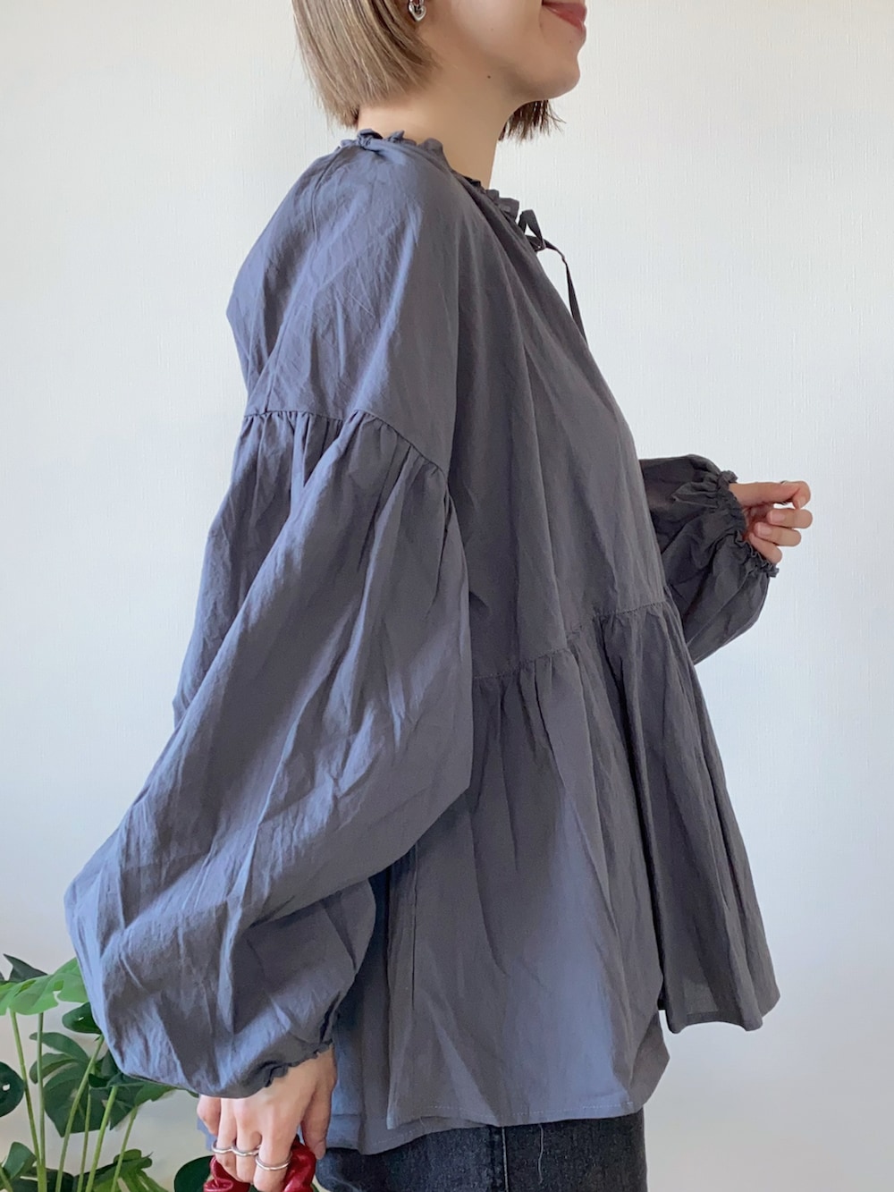 グレー系のシャツ/ブラウス、ブラック系のデニムパンツ、レッド系のボストンバッグを着用したレディースの春コーディネートの5枚目の写真
