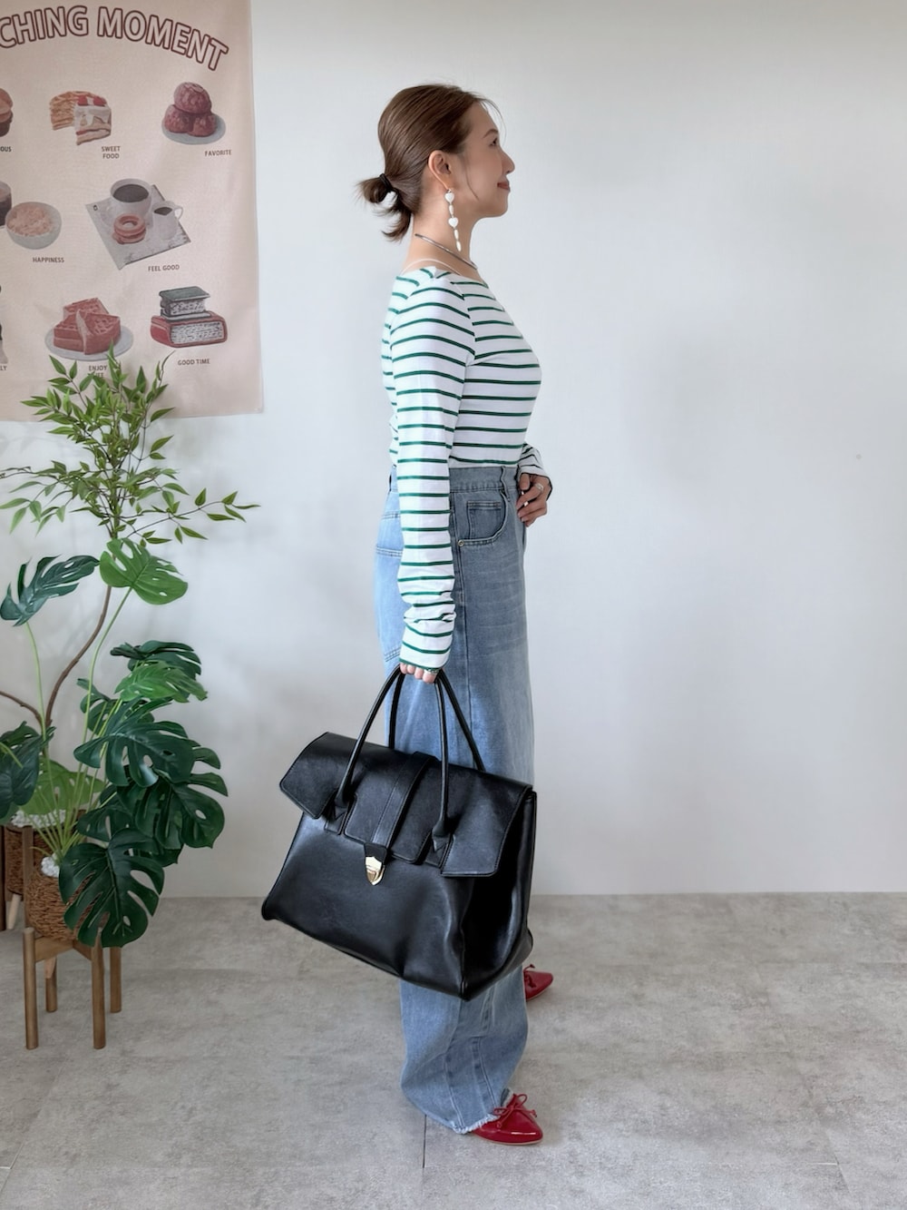 レッド系のバレエシューズ、ブラック系のボストンバッグ、グリーン系のTシャツ/カットソーを着用したレディースの春コーディネートの2枚目の写真