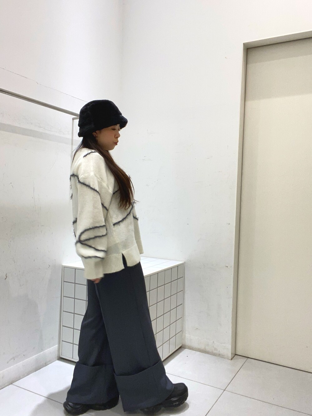 ホワイト系のニット/セーター、グレー系のその他パンツを着用したレディースの秋コーディネートの2枚目の写真