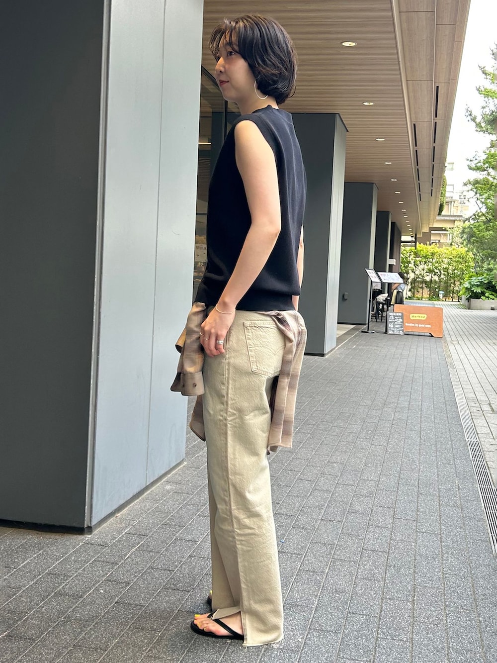 ベージュ系のデニムパンツ、ブラウン系のシャツ/ブラウス、ブラック系のベストを着用したレディースの夏コーディネートの3枚目の写真