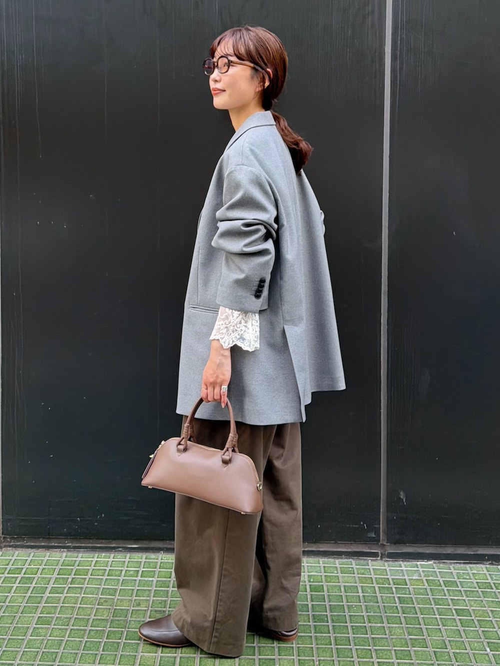 ブラウン系のチノパンツ、ホワイト系のシャツ/ブラウス、ブラウン系のショルダーバッグを着用したレディースの秋コーディネートの2枚目の写真