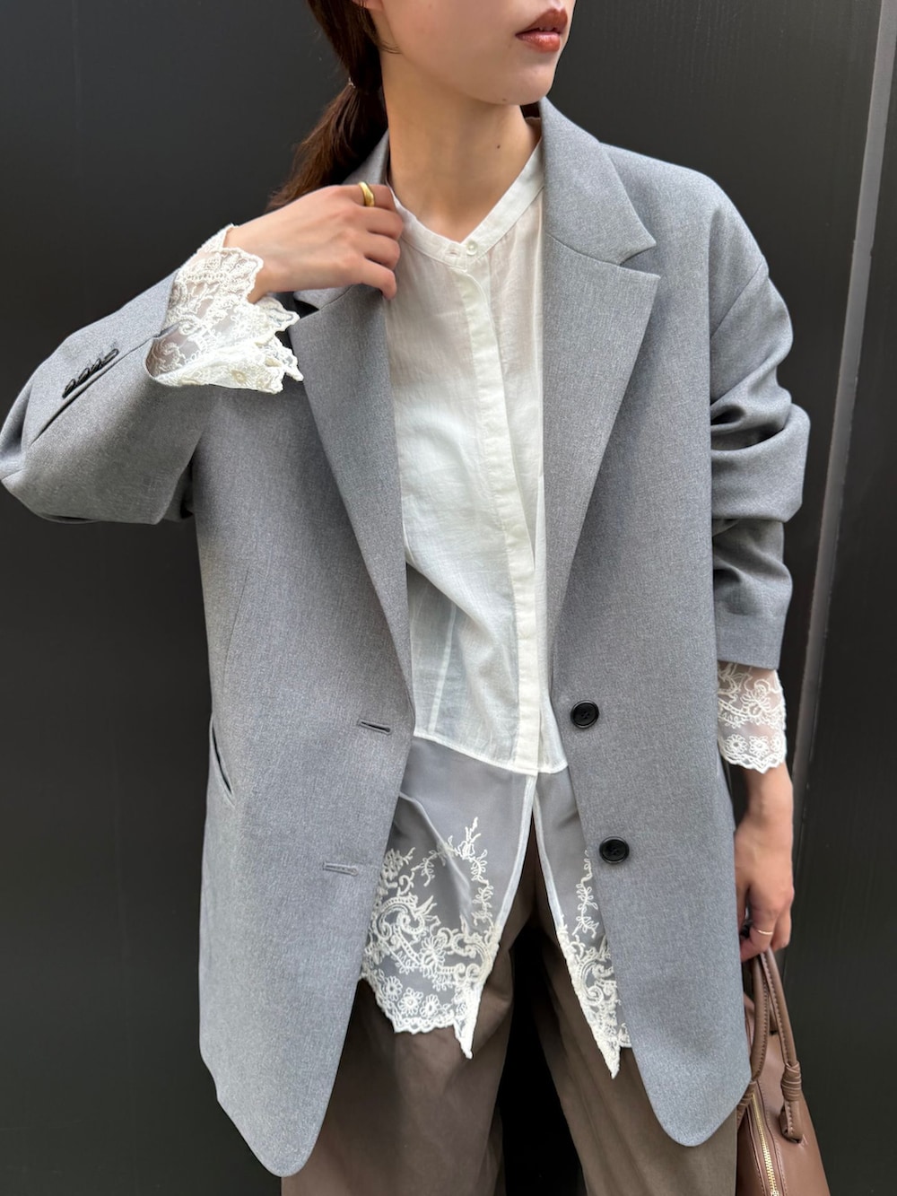 ブラウン系のチノパンツ、ホワイト系のシャツ/ブラウス、ブラウン系のショルダーバッグを着用したレディースの秋コーディネートの5枚目の写真