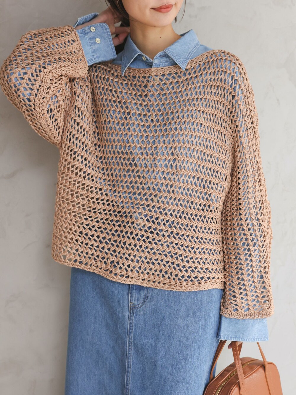 ブルー系のシャツ/ブラウス、ブルー系のデニムスカート、ベージュ系のニット/セーターを着用したレディースの冬コーディネートの4枚目の写真