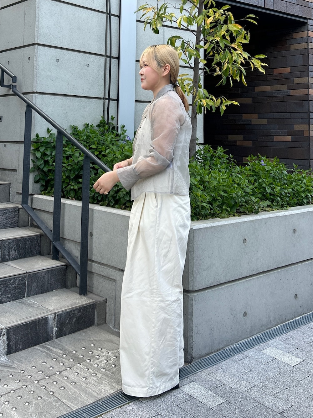 グレー系のシャツ/ブラウス、ホワイト系のその他パンツ、ブラック系のパンプスを着用したレディースの春コーディネートの3枚目の写真