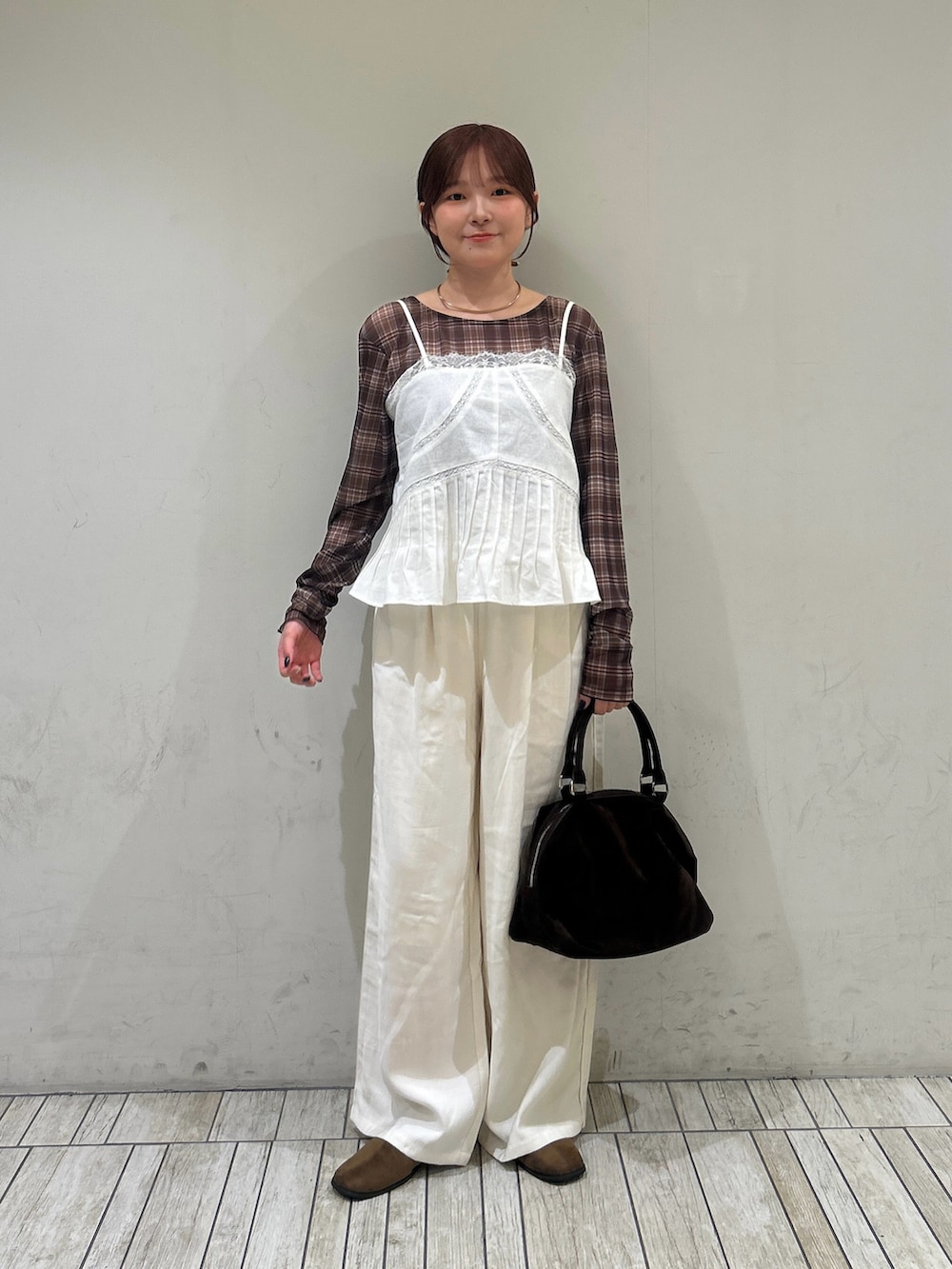 ホワイト系のキャミソール、ブラウン系のTシャツ/カットソー、ブラウン系のボストンバッグを着用したレディースの夏コーディネートの3枚目の写真