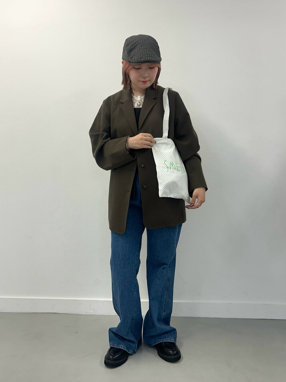 ブルー系のデニムパンツ、ブラック系のローファー、その他のトートバッグを着用したレディースの秋コーディネートの2枚目の写真