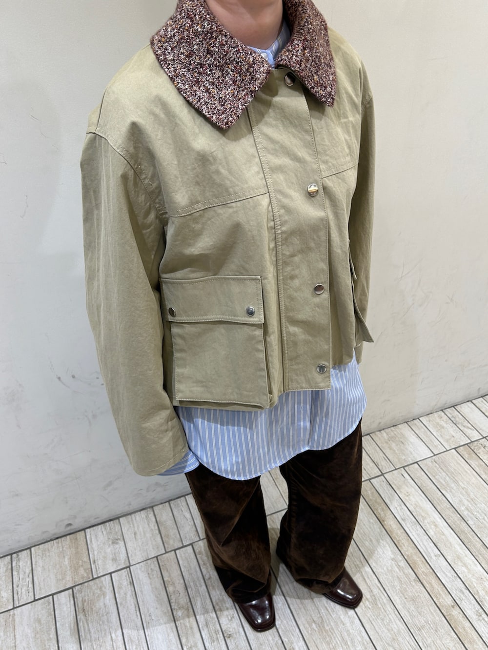 ベージュ系のブルゾン、ブルー系のシャツ/ブラウス、ブラウン系のデニムパンツを着用したレディースの冬コーディネートの6枚目の写真