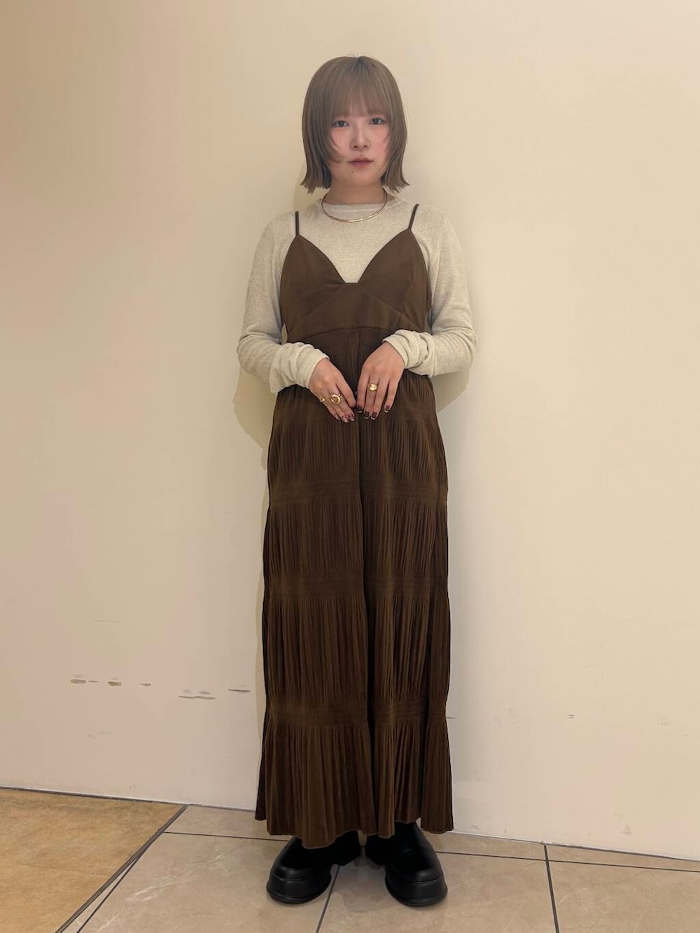 ホワイト系のダウンジャケット/コート、ブラウン系のワンピース、ホワイト系のニット/セーターを着用したレディースの冬コーディネートの4枚目の写真