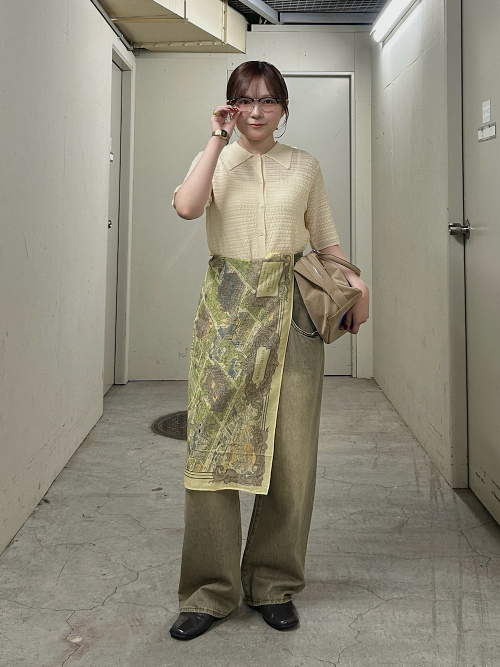 ホワイト系のニット/セーター、グリーン系のデニムパンツ、グレー系のその他シューズを着用したレディースの春コーディネートの2枚目の写真