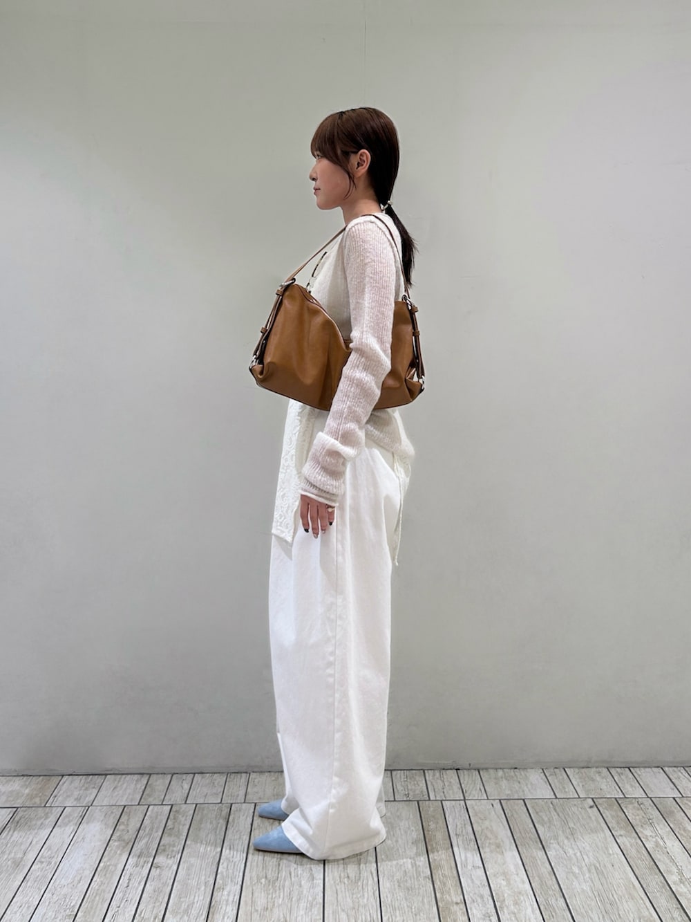 ホワイト系のその他パンツ、ブルー系のサンダル、イエロー系のショルダーバッグを着用したレディースの秋コーディネートの3枚目の写真