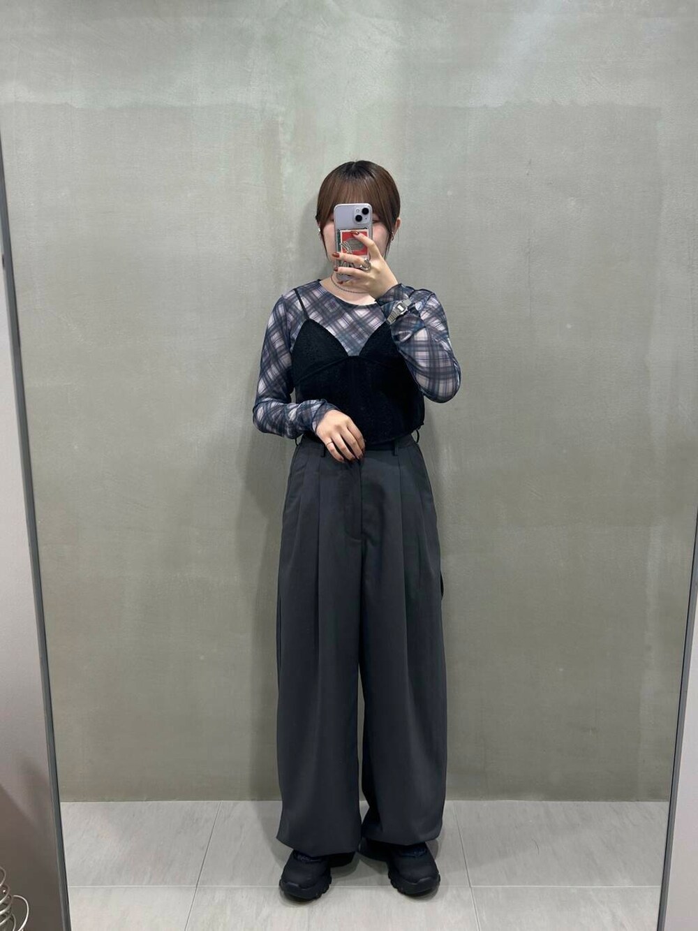 ブラック系のスニーカー、グレー系のスラックス、ブラック系のその他トップスを着用したレディースの秋コーディネートの2枚目の写真