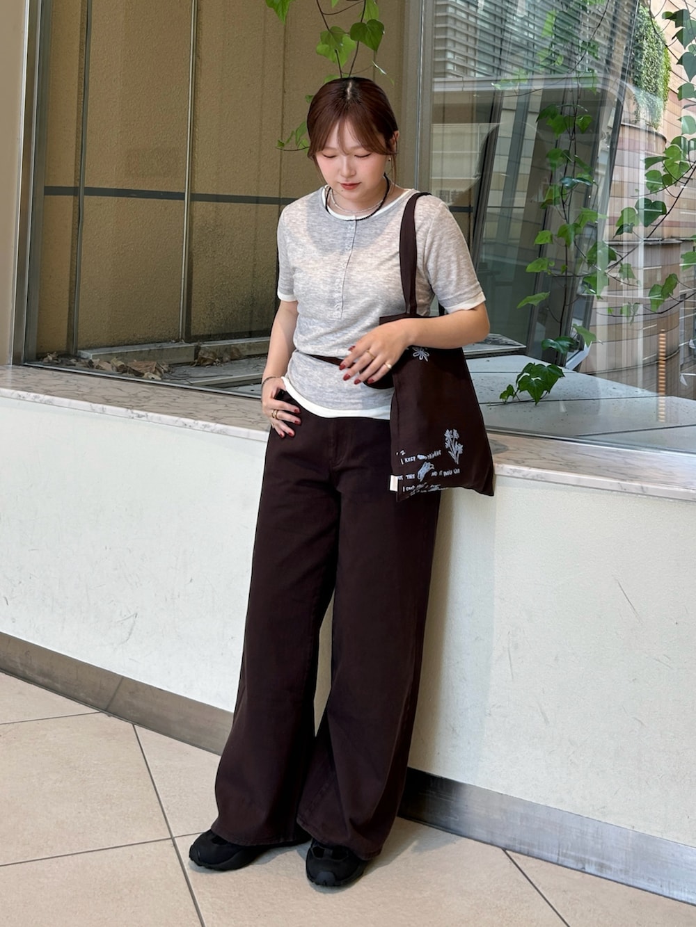 グレー系のTシャツ/カットソー、ブラウン系のその他パンツ、ブラック系のスニーカーを着用したレディースの春コーディネートの2枚目の写真
