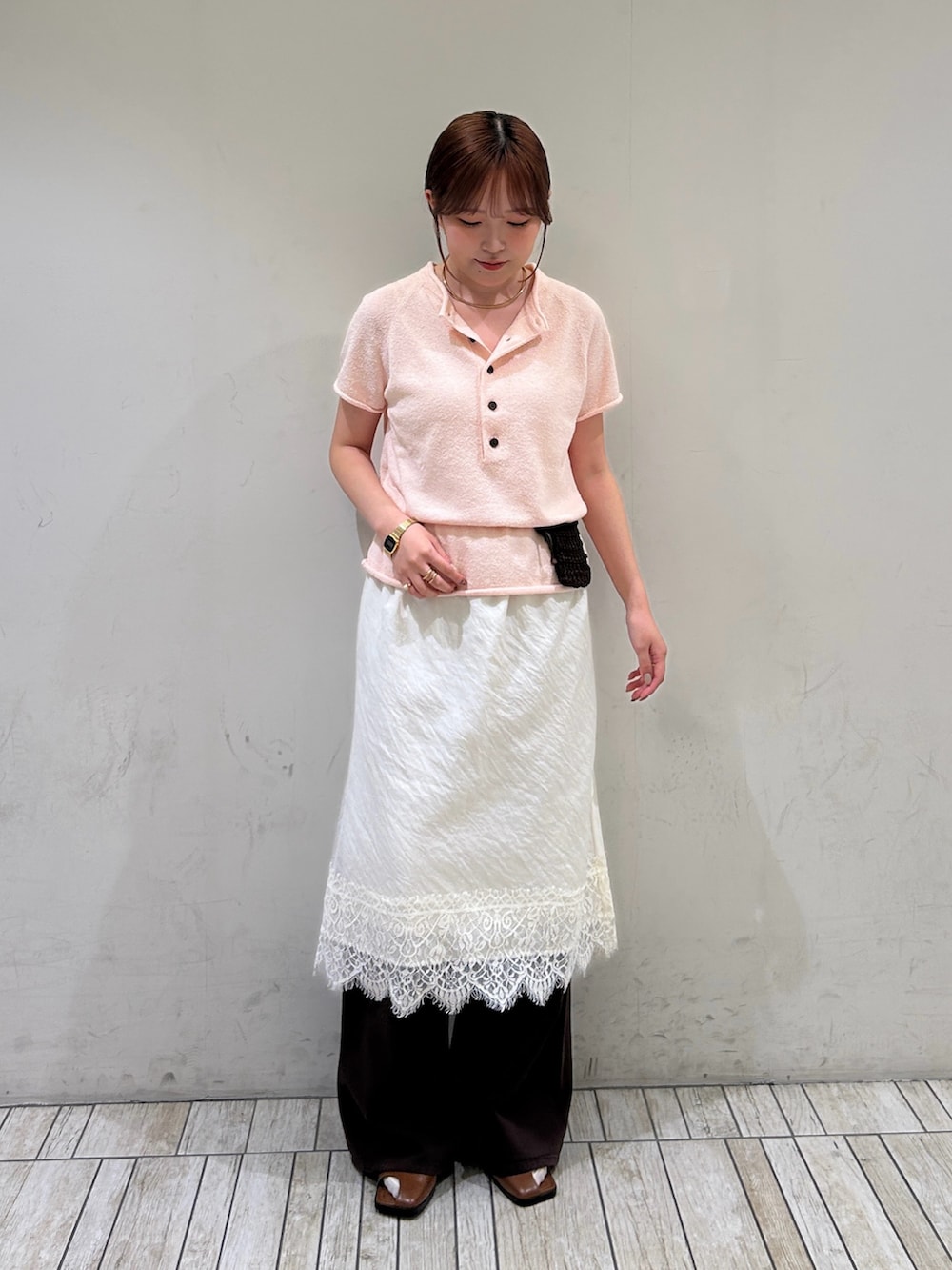 ピンク系のニット/セーター、ホワイト系のスカート、ブラウン系のその他パンツを着用したレディースの夏コーディネートの2枚目の写真