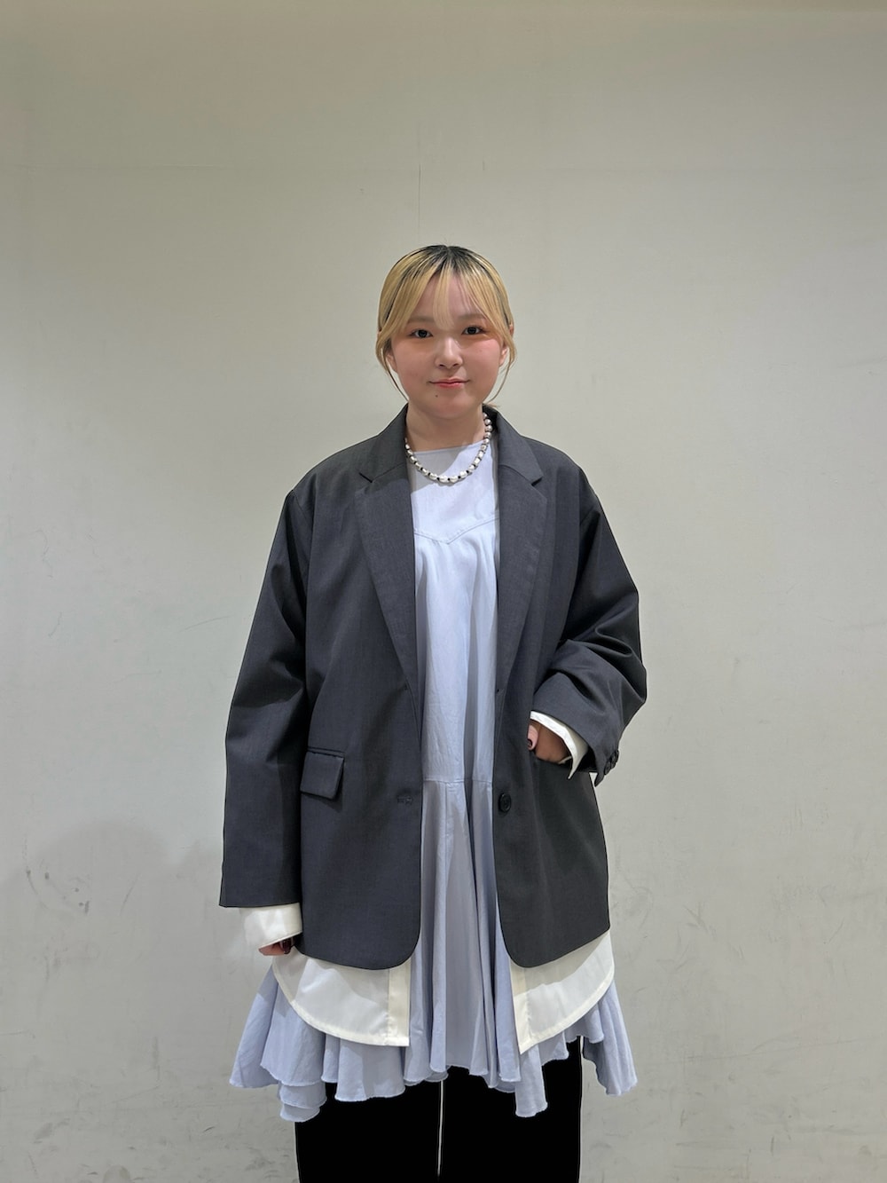 ブラック系のデニムパンツ、グレー系のその他アウター、ブルー系のワンピースを着用したレディースの冬コーディネートの4枚目の写真