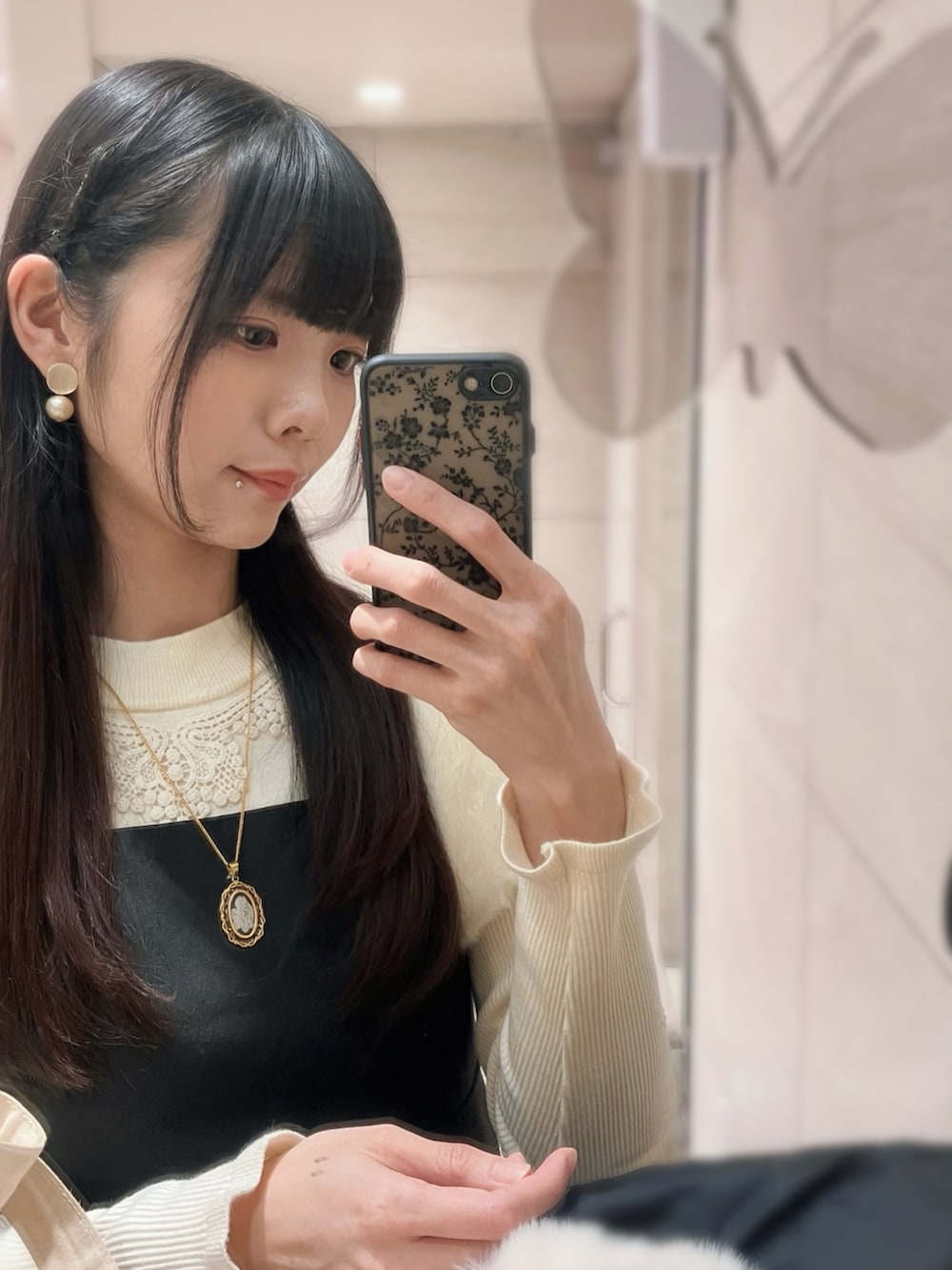 ブラック系のワンピース、ブラック系のローファー、ベージュ系のニット/セーターを着用したレディースの冬コーディネートの2枚目の写真