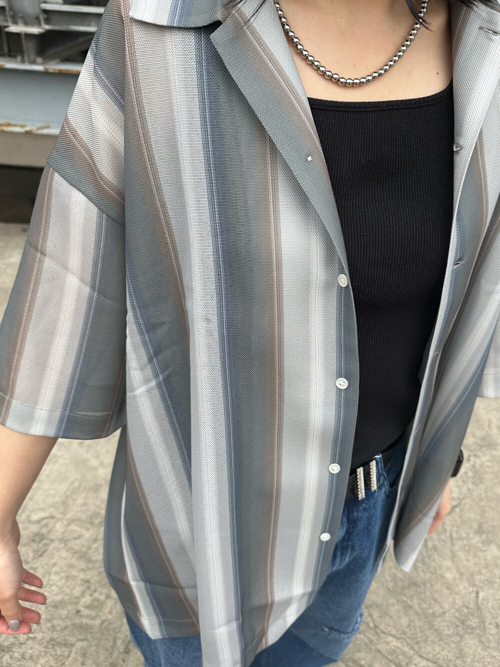 グレー系のシャツ/ブラウスを着用したレディースの春コーディネートの2枚目の写真