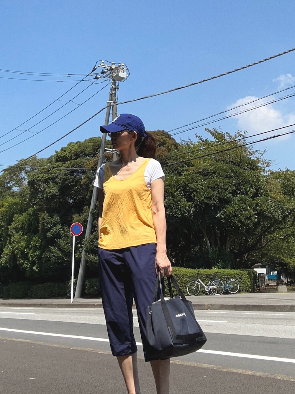 ブルー系のパンツ、ブルー系のキャップを着用したレディースの夏コーディネートの2枚目の写真