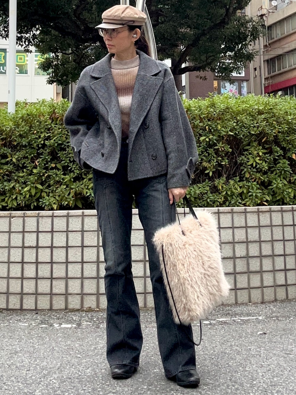 ブラック系のデニムパンツ、グレー系のジャケット/アウター、ブラウン系のニット/セーターを着用したレディースの冬コーディネートの2枚目の写真