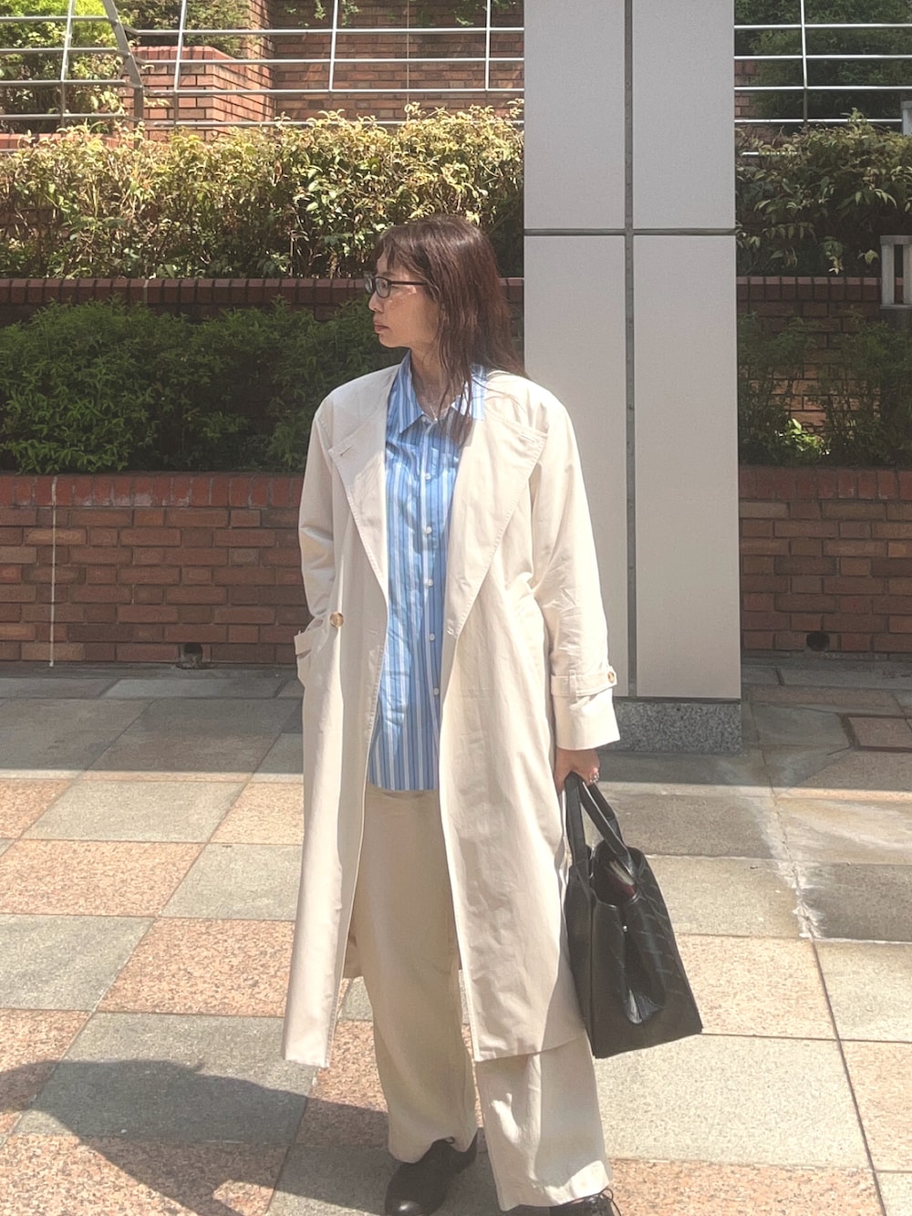 ブルー系のシャツ/ブラウス、ホワイト系のスラックス、ホワイト系のノーカラーコートを着用したレディースの春コーディネートの2枚目の写真