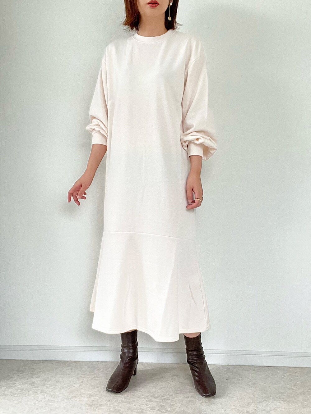 ホワイト系のワンピース、ブラウン系のショルダーバッグ、ホワイト系のスニーカーを着用したレディースの夏コーディネートの3枚目の写真