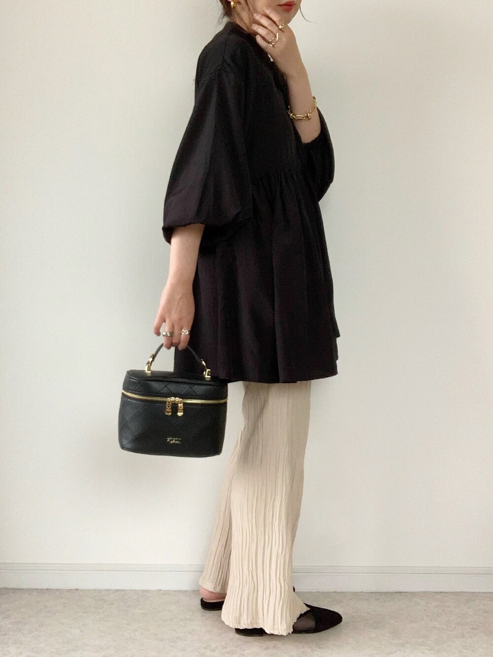 ホワイト系のその他パンツ、ブラック系のショルダーバッグ、ブラック系のサンダルを着用したレディースの春コーディネートの2枚目の写真