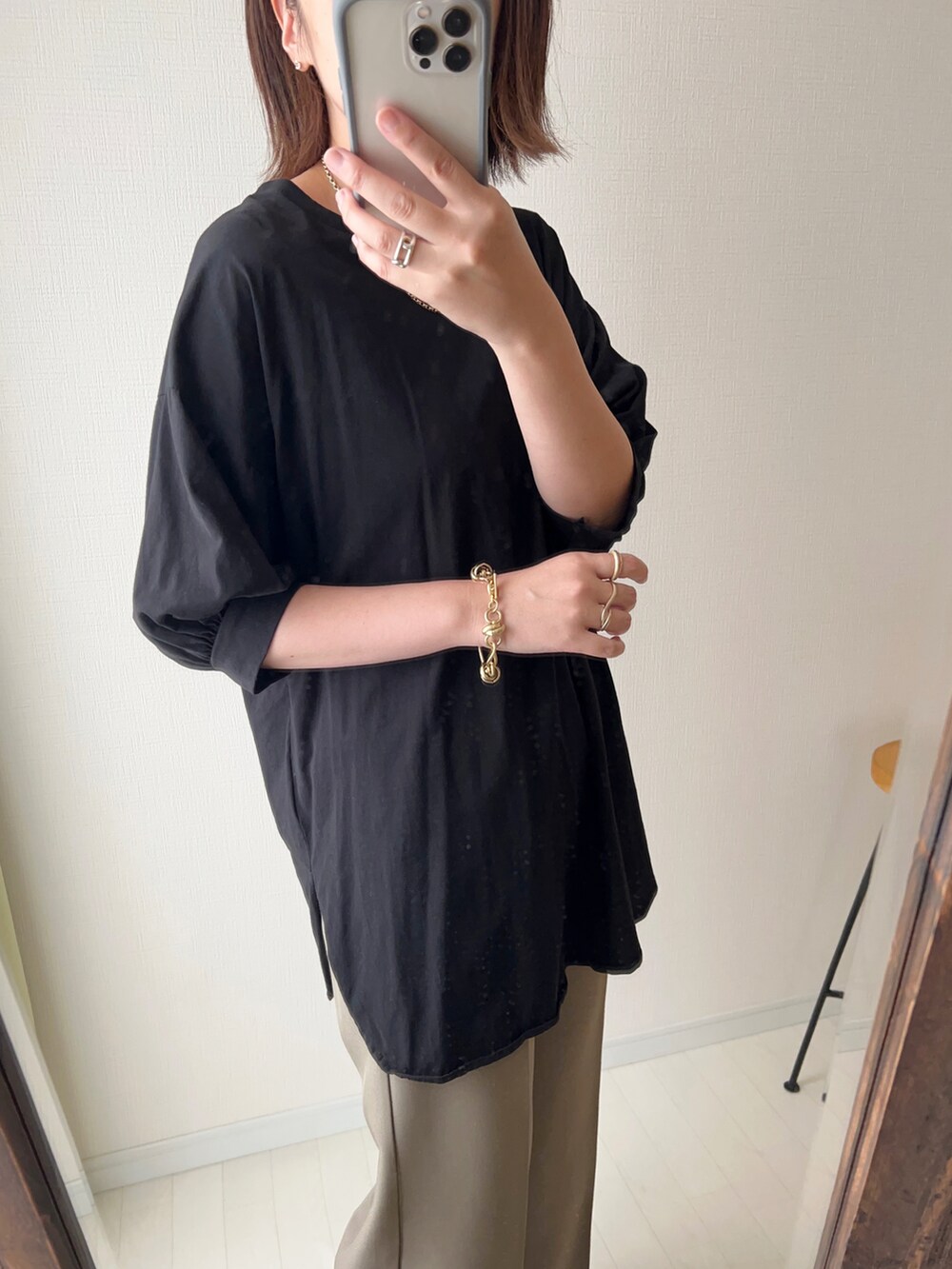 ブラック系のTシャツ/カットソー、ブラウン系のスラックス、ベージュ系のサンダルを着用したレディースの夏コーディネートの2枚目の写真