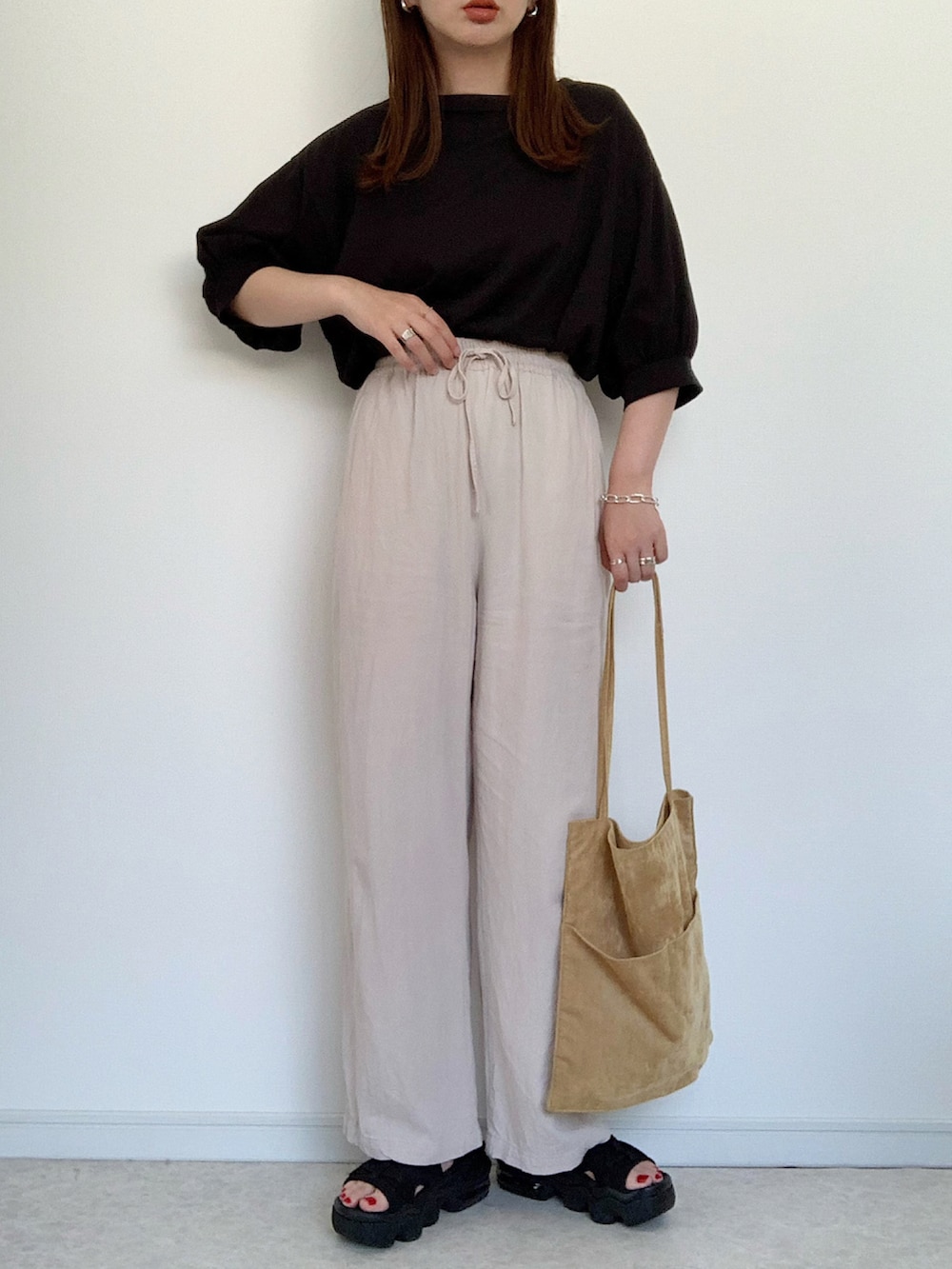 グリーン系のTシャツ/カットソー、ホワイト系のその他パンツ、ブラック系のトートバッグを着用したレディースの夏コーディネートの3枚目の写真