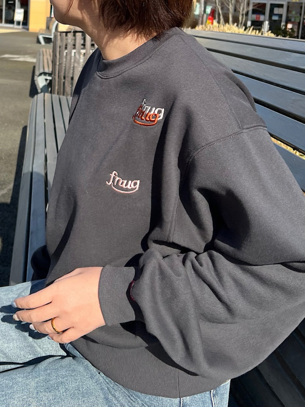 ブルー系のデニムパンツ、グレー系のスウェット、ホワイト系のスニーカーを着用したレディースの冬コーディネートの3枚目の写真