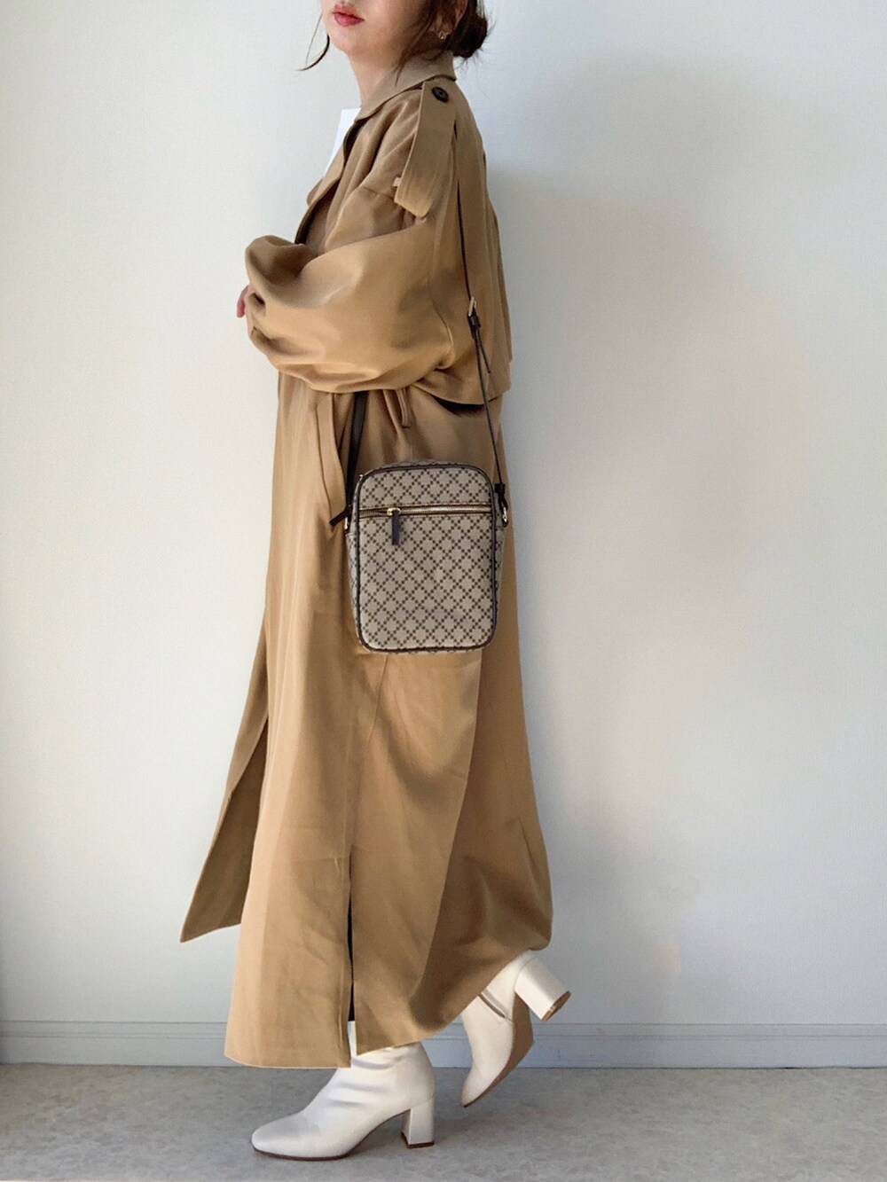 ベージュ系のトレンチコート、ホワイト系のTシャツ/カットソー、ベージュ系のその他パンツを着用したレディースの冬コーディネートの3枚目の写真