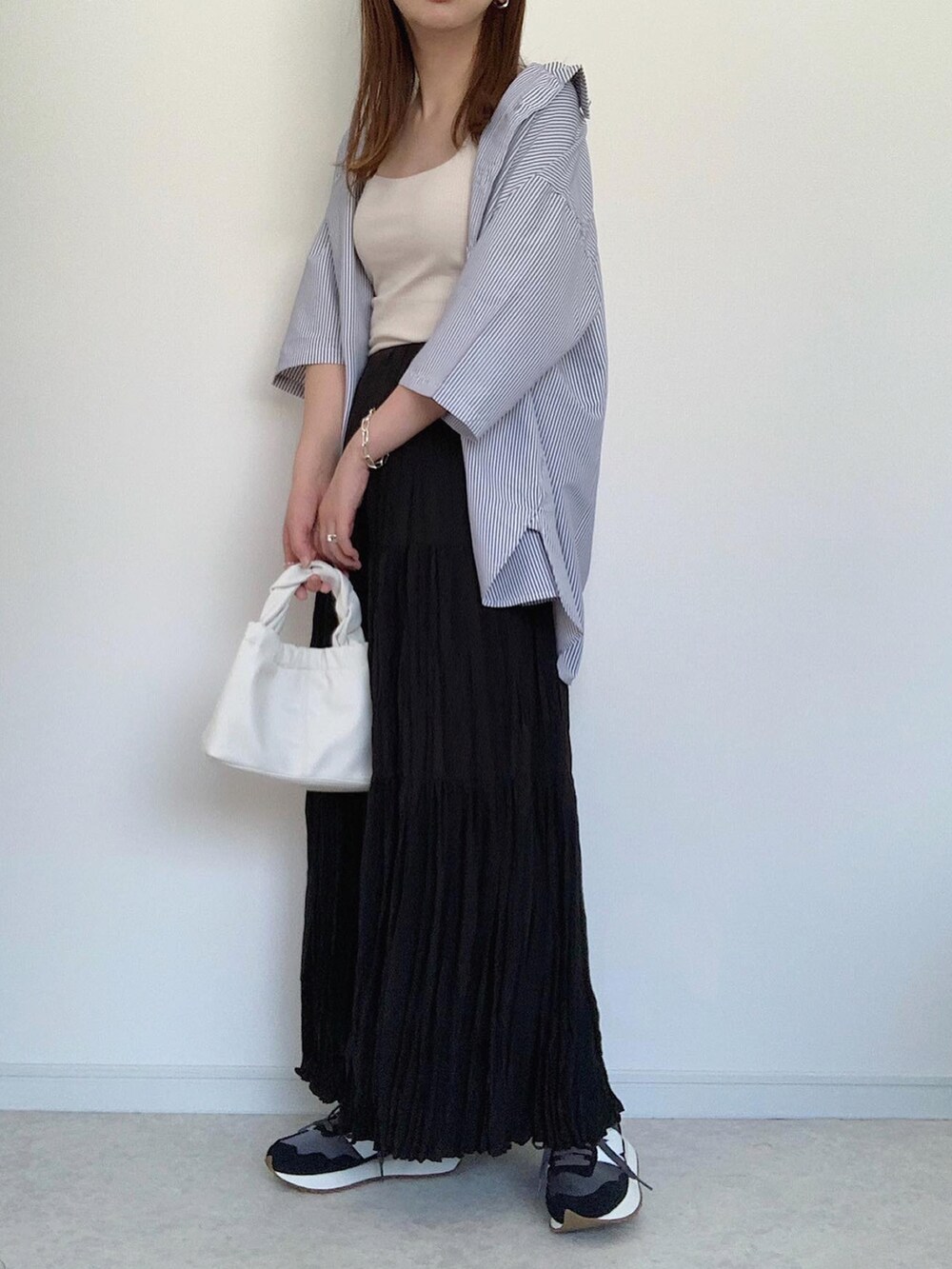 ブルー系のシャツ/ブラウス、ブラウン系のスラックス、ホワイト系のショルダーバッグを着用したレディースの夏コーディネートの3枚目の写真