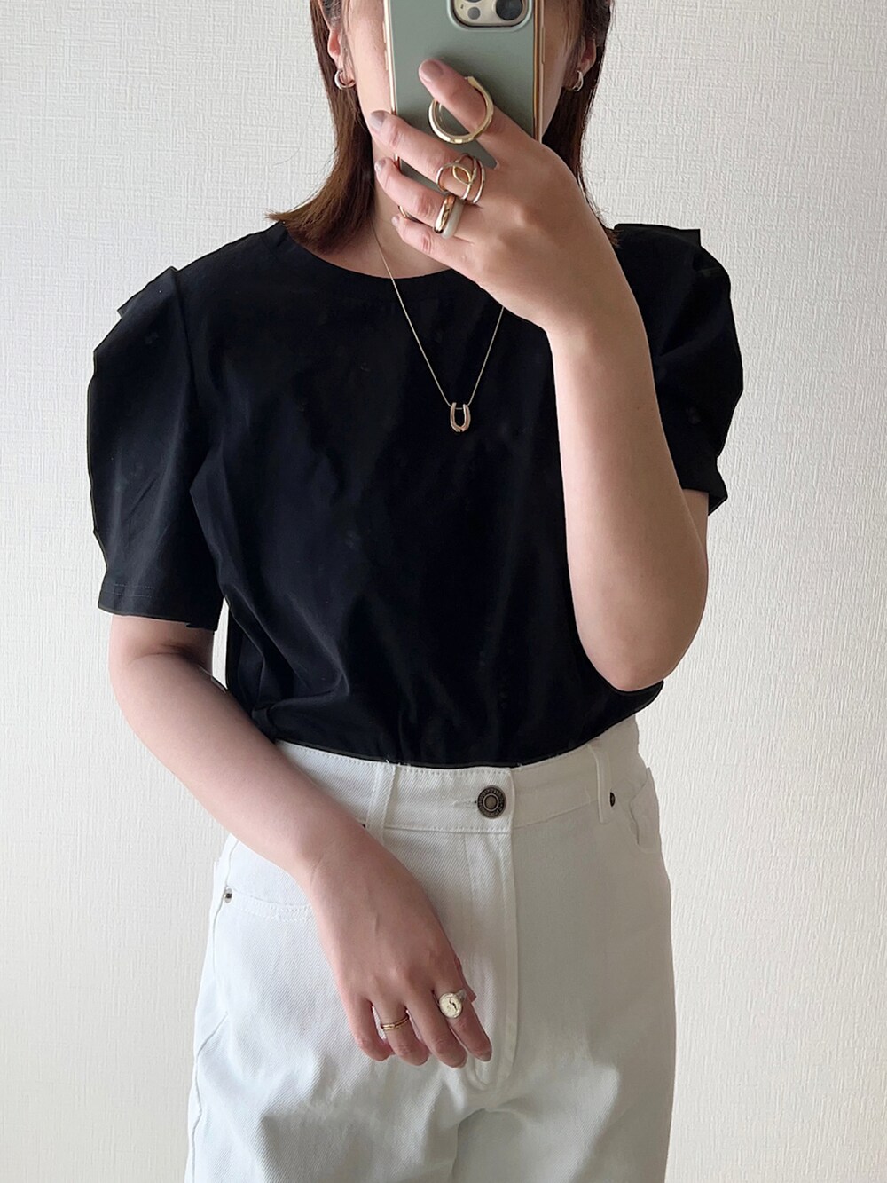 ブラック系のTシャツ/カットソー、ホワイト系のデニムパンツ、ベージュ系のサンダルを着用したレディースの春コーディネートの2枚目の写真