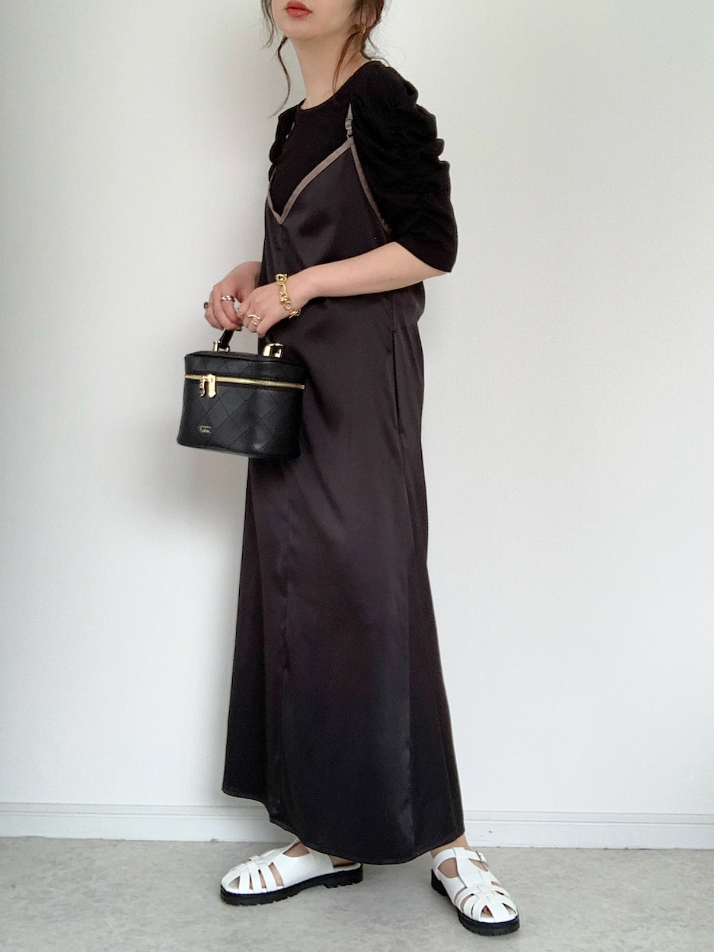 ブラック系のTシャツ/カットソー、ブラック系のワンピース、ホワイト系のサンダルを着用したレディースの春コーディネートの2枚目の写真