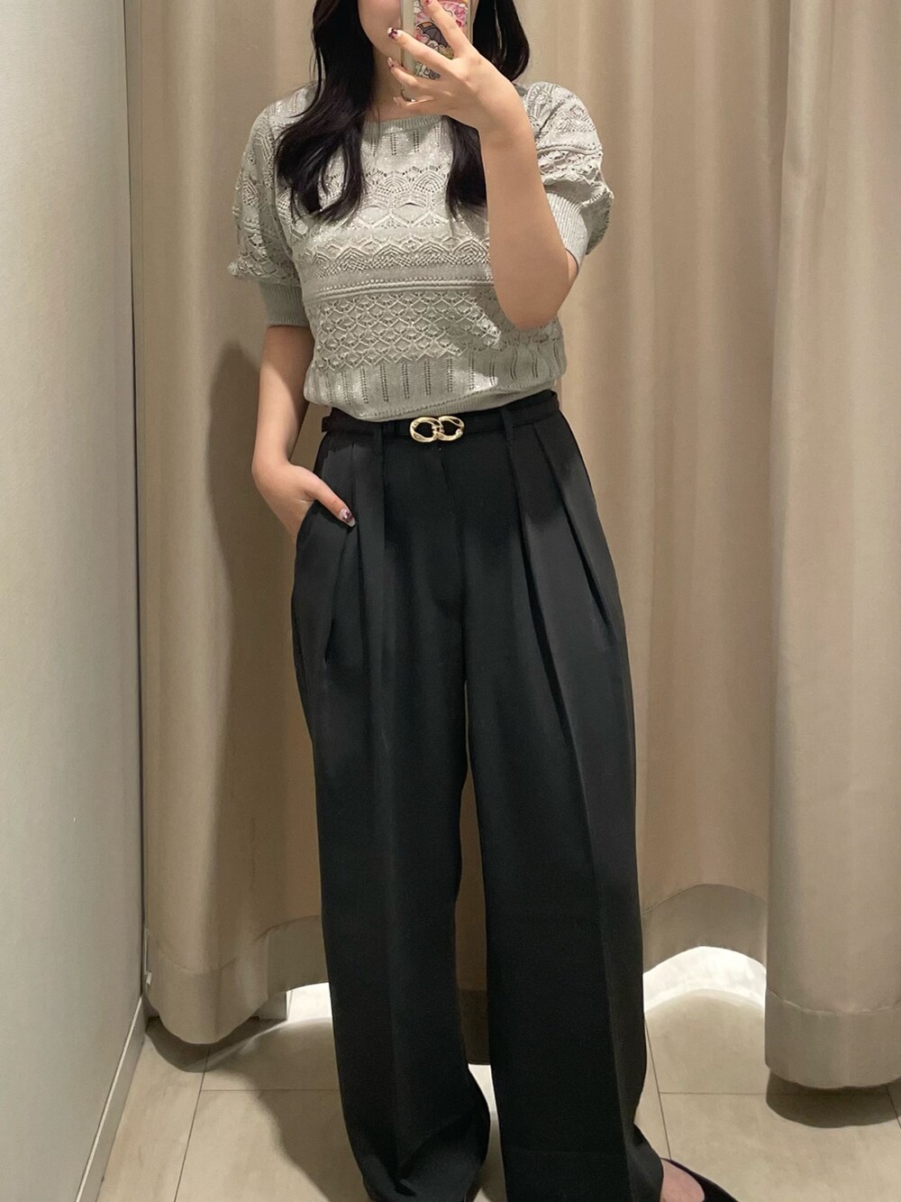 ベージュ系のニット/セーター、ブラウン系のトートバッグ、ブラック系のベルトを着用したレディースの夏コーディネートの3枚目の写真