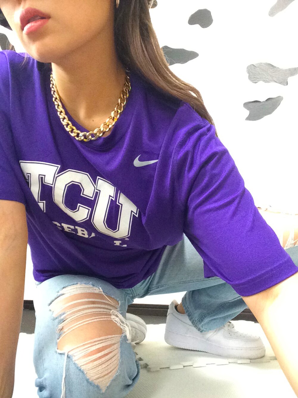 パープル系のTシャツ/カットソー、ホワイト系のバッグ、ブルー系のデニムパンツを着用したレディースの春コーディネートの2枚目の写真