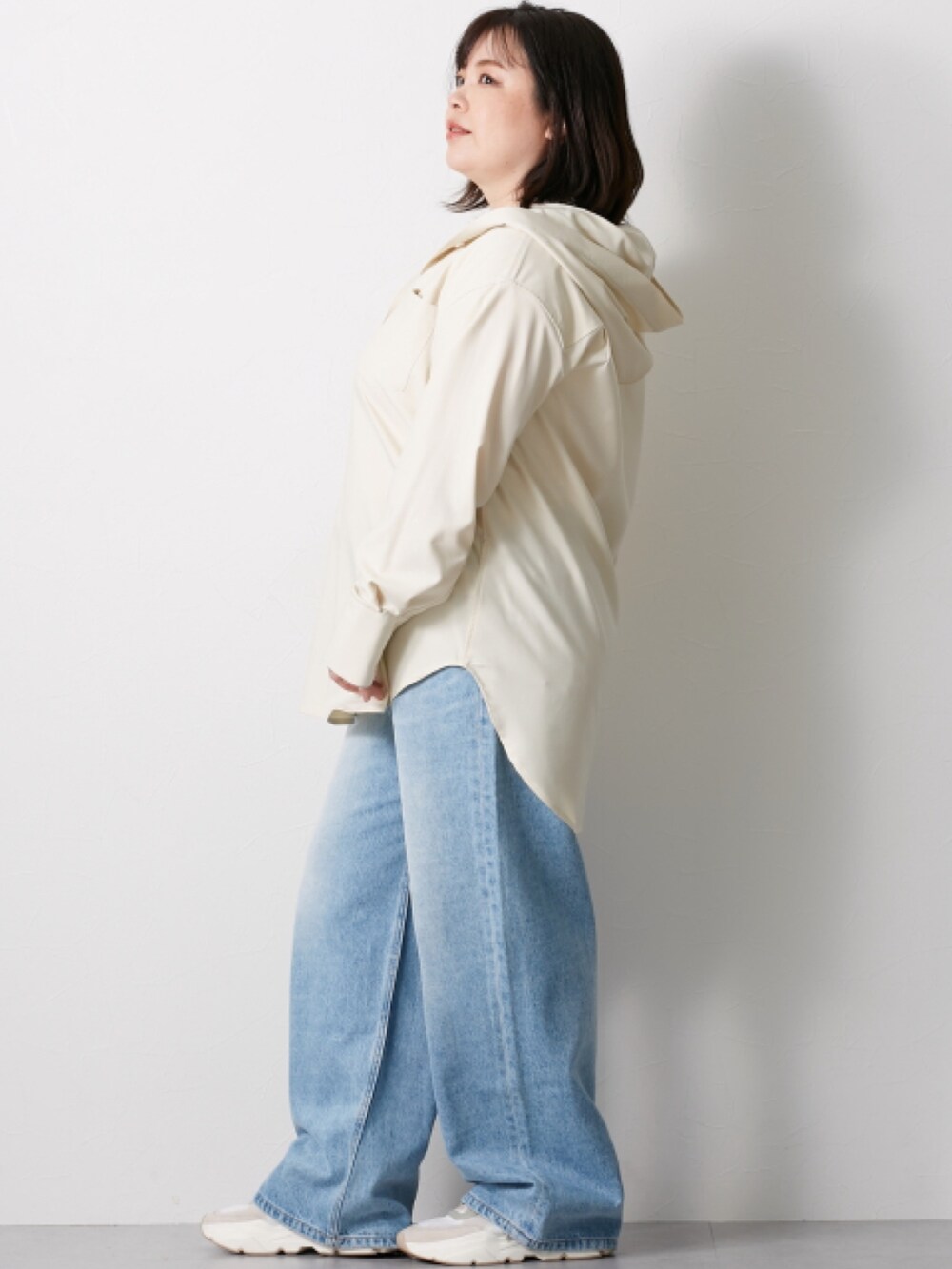 ベージュ系のシャツ/ブラウス、ブルー系のデニムパンツを着用したレディースの冬コーディネートの2枚目の写真