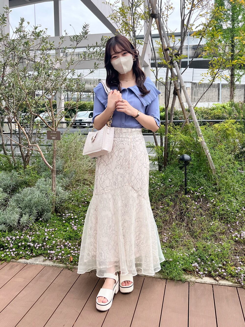 ホワイト系のスカート、ブルー系のTシャツ/カットソー、ホワイト系のサンダルを着用したレディースの春コーディネートの2枚目の写真