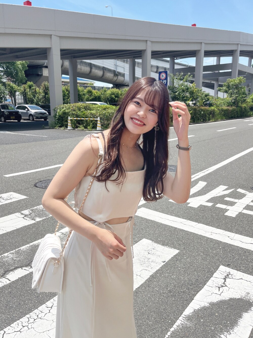 ホワイト系のワンピース、ホワイト系のショルダーバッグ、ホワイト系のサンダルを着用したレディースの夏コーディネートの2枚目の写真