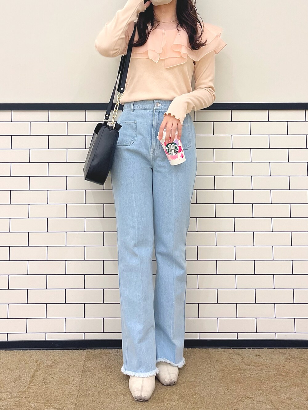 ブルー系のデニムパンツ、ピンク系のTシャツ/カットソー、ブラック系のショルダーバッグを着用したレディースの春コーディネートの3枚目の写真