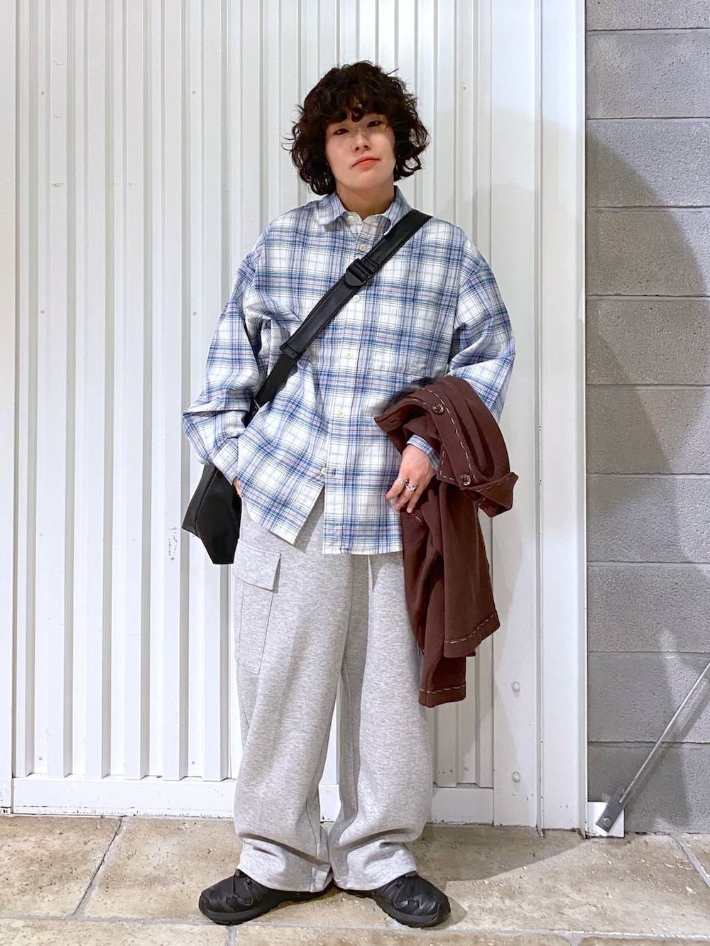 ブラック系のショルダーバッグ、ブラック系のスニーカー、ブラウン系のカーディガン/ボレロを着用したメンズの秋コーディネートの4枚目の写真