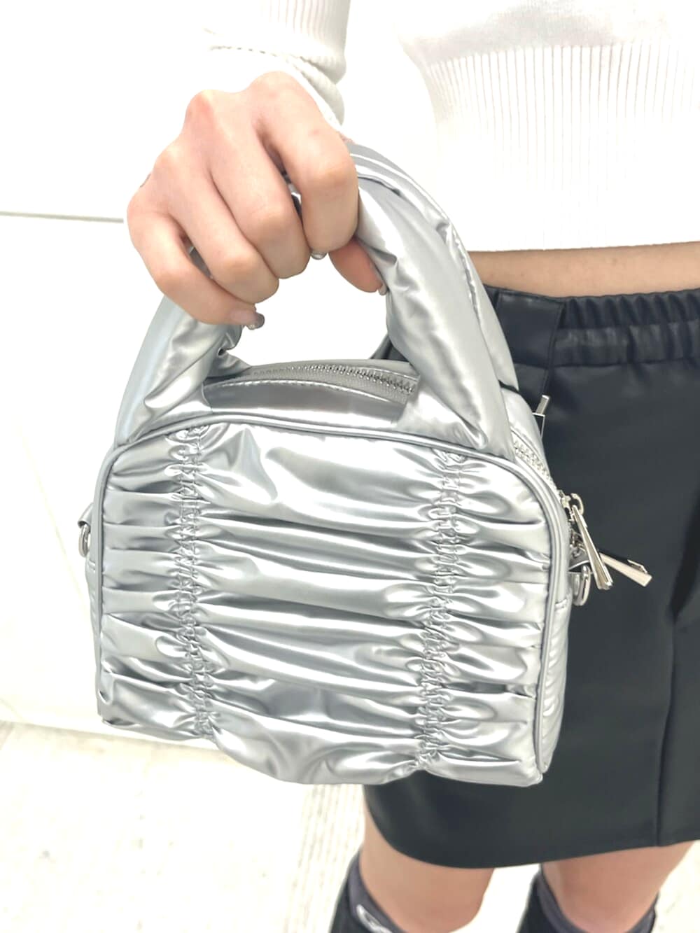 ブラック系のブルゾン、ブラック系のスカート、ブラック系のスニーカーを着用したレディースの春コーディネートの10枚目の写真