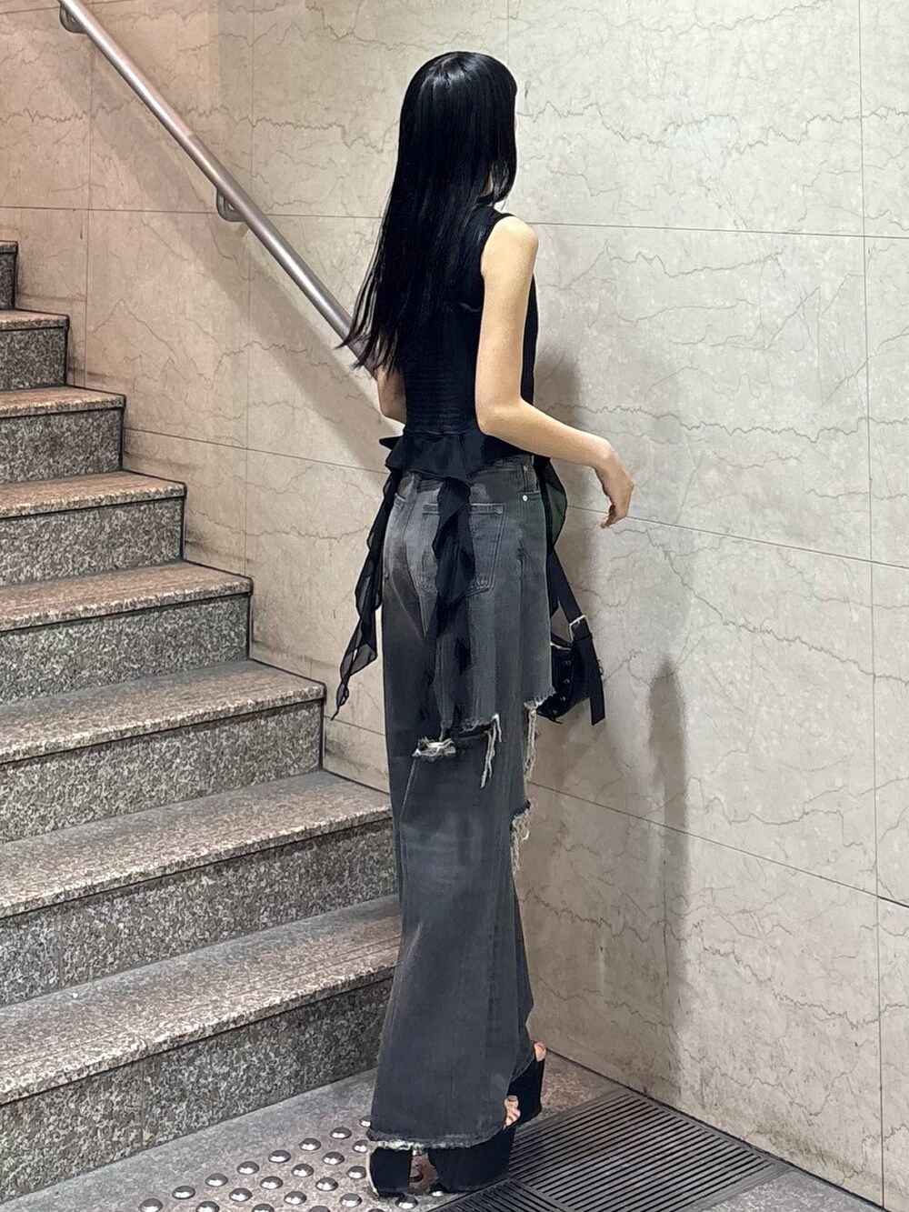 ブラック系のTシャツ/カットソー、ブラック系のニット/セーター、ブラック系のデニムパンツを着用したレディースの春コーディネートの2枚目の写真